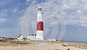 Panoramic view of the Isle of Portland bill lighthouse near Weymoth Dorset coast England UK with a cloudy sky and the ocean in the