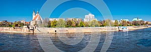 Panoramic view of Johannis church, park, and Elbe river bank in Magdeburg, Germany