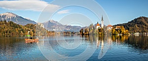 Panoramic view of Julian Alps, Lake Bled with St. Marys Church of the Assumption on the small island. Bled, Slovenia