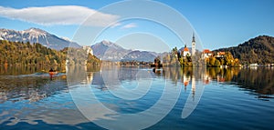 Panoramic view of Julian Alps, Lake Bled with St. Marys Church of the Assumption on the small island. Bled, Slovenia