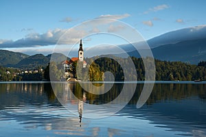 Panoramic view of Lake Bled with the church on the island and mountains in the background in the morning