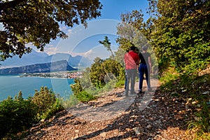 Panoramic view on Lake Garda from the Busatte-Tempesta trail near Nago-Torbole with the iron staircase,  Torbole  town surrounded