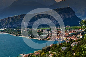 Panoramic view on Lake Garda from the Busatte-Tempesta trail near Nago-Torbole with the iron staircase,  Torbole  town surrounded