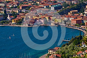 Panoramic view on Lake Garda from the Busatte-Tempesta trail near Nago-Torbole with the iron staircase,  Torbole  town surrounded photo