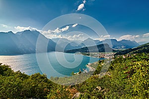 Panoramic view on Lake Garda from the Busatte-Tempesta trail near Nago-Torbole with the iron staircase,  Torbole  town surrounded photo