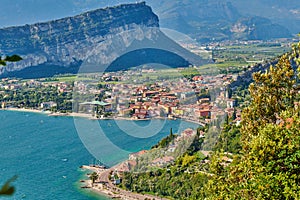 Panoramic view on Lake Garda from the Busatte-Tempesta trail near Nago-Torbole with the iron staircase,  Torbole  town surrounded photo