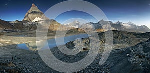 Panoramic view from lake under Matterhorn, Switzerland.