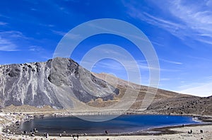 Panoramic view of the las lagunas in the crater of the old Nevado de Toluca volcano.Lake and mountain with blue sky.