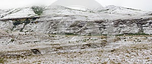 Panoramic view of light snowfall at Golden Gate as it covers the Drakensberg mountains on a cold morning.
