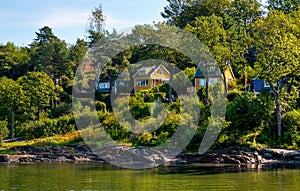 Panoramic view of Lindoya island on Oslofjord harbor near Oslo, Norway, with Lindoya Ost marina and summer cabin houses at