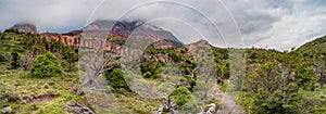 Panoramic view of lonely hikers walking through surreal landscape in Torres del Paine National Park, Patagonia, Chile, details