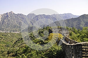 Panoramic view from the majestic Great Wall of China to the surrounding landscape and forests. The horizon is in the