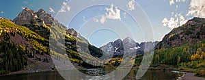 Panoramic view of Maroon Bells peaks and fall colors in the Rocky Mountain National Park