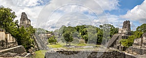 Panoramic view of Mayan Temples of Gran Plaza or Plaza Mayor at Tikal National Park - Guatemala