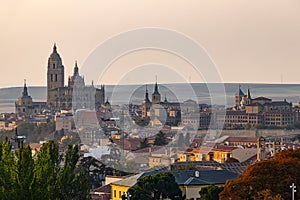 Panoramic view of medieval city of Segovia at sunset with the wall surrounding the old city, Spain