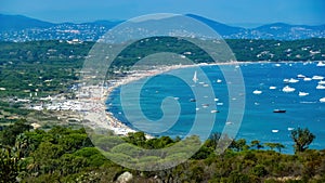 Panoramic view mediterranean sea bay with boats against blue summer sky and mountains background - Plage de pampelonne, St. Tropez