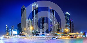 Panoramic view of metro station and road in Financial district at night, Dubai, UAE