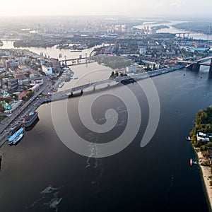 Panoramic view of a modern city with a river, unfinished bridge and park part of the city