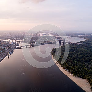 Panoramic view of a modern city with a river, unfinished bridge and park part of the city