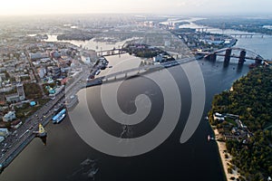 Panoramic view of a modern city with a river, unfinished bridge and park part of the city