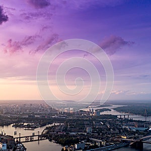 Panoramic view of a modern city with a river, unfinished bridge and park part of the city