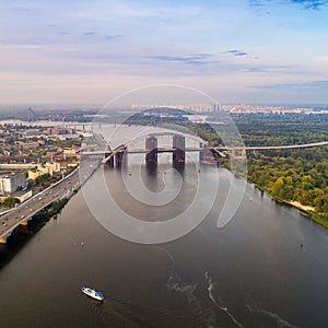 Panoramic view of a modern city with a river, unfinished bridge and park part of the city