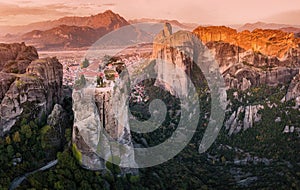 Panoramic view of the Monastery of the Holy Trinity in Meteora at sunrise and Kalambaka town at the distance. Tourist and