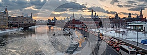 Panoramic view of Moscow Kremlin and Moscow river with street illumination at sunset