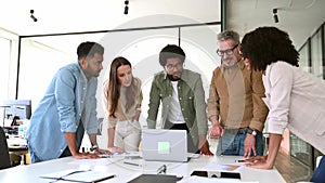 A panoramic view of a motivated team intensely focused on a computer screen