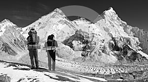 Panoramic view of Mount Everest with two tourists