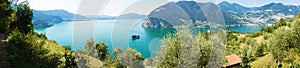 Panoramic view of mountain lake with island in the middle. Panorama from Monte Isola Island with Lake Iseo. Italian landscape.