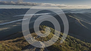 Panoramic view from a mountain peak reveals a vast landscape photo