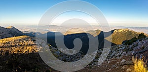 A panoramic view of the mountainous landscape of Spain at sunset. photo