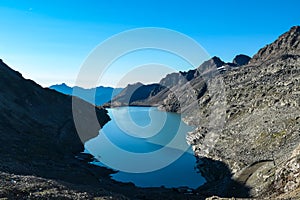 Panoramic view on the mountains of Hohe Tauern Alps in Carinthia, Austria, Europe. A lake reflection and water reservoir on the