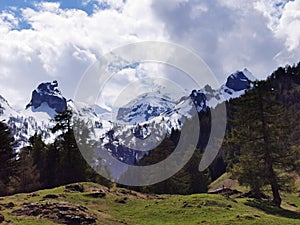 Panoramic view of mountaintops against cloudy sky