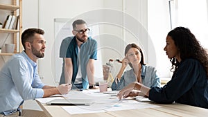 Panoramic view of multiracial employees brainstorm at meeting