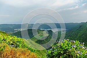 Panoramic view of natural landscape in the Azores, wonderful island of Portugal. Beautiful lagoons in volcanic craters and green f