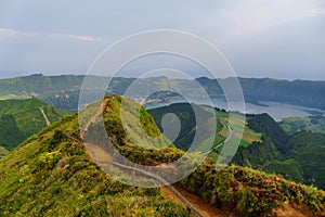 Panoramic view of natural landscape in the Azores, wonderful island of Portugal. Beautiful lagoons in volcanic craters and green f