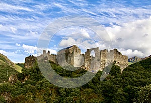 Mountain landscape with a castle on the top of the mountain. photo