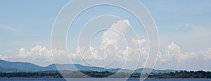Panoramic view of nice clouds in blue sky with mountain and reservoir background