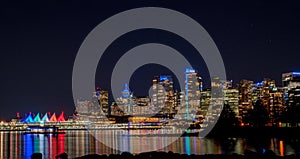 Panoramic view of night skyline of city of Vancouver seen from Stanley Park