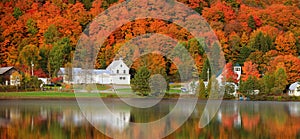 Panoramic view of old barn by the lake with fall foliage near Danville, Vermont