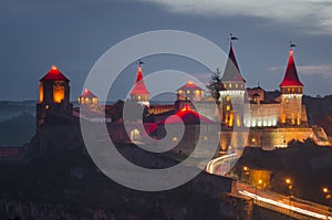 Panoramic view of the old fortress in Kamyanets-Podilsky, Ukraine. The towers of the fortress are illuminated with bright lights