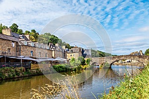 panoramic view of old stone bridge and historical medieval houses reflecting in La Rance river in Dinan town port