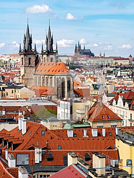 Panoramic view of the old town of Prague, Czech Republic, with red rooftops and the castle on the background