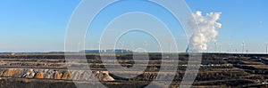 Panoramic view open cast mining, power plant and wind energy