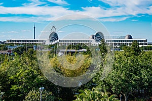 Panoramic view of Orlando Convention Center and green forest background on lightblue sky cloudy background2