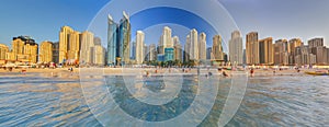 Panoramic view over beach and skyline of Marina district in Dubai during sunset