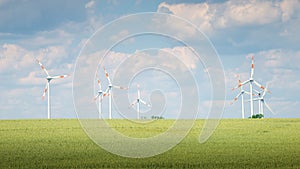 Panoramic view over beautiful green farm landscape with light and shadow waves in Germany with clouds in sky, wind turbines to