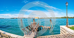 Panoramic view over busy Grand Canal and pier, promenade embankment at Lido island in Venice, Italy